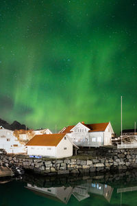 Buildings against sky at night