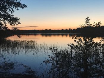 Scenic view of lake against sky during sunset