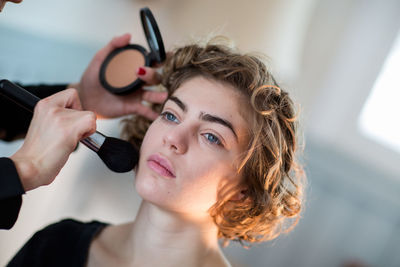 Close-up of woman holding camera