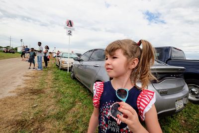 Rear view of people on road against sky