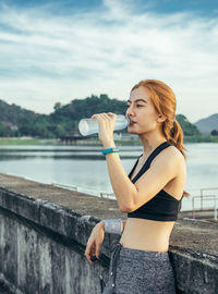 Full length of woman at lake against sky