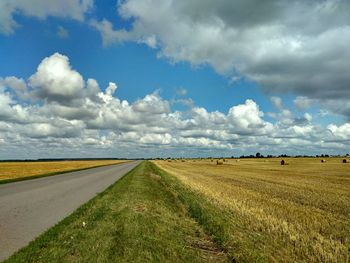 Scenic view of agricultural field against sky