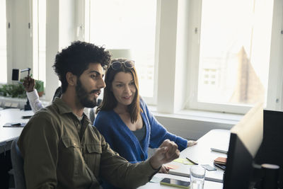 Two professionals discussing in office