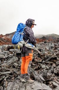 Rear view of man standing on rock