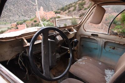 Abandoned car parked by window