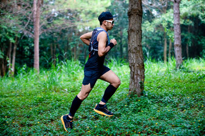 Full length of man running in forest