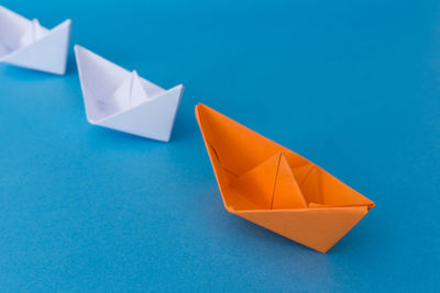 High angle view of paper flag against blue background
