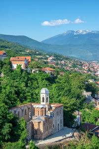 Historic building by mountains against sky