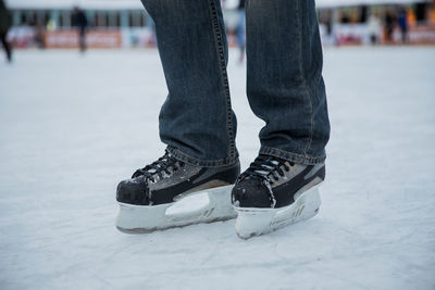 Low section of person wearing shoes on snow