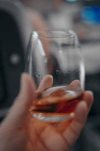 Midsection of person holding glass