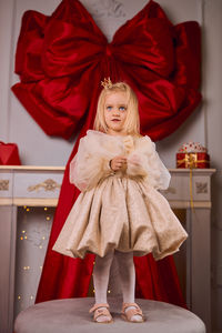 Rear view of woman standing against wall