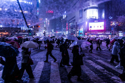 Crowd on road in city at night