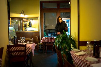 Portrait of woman standing in restaurant