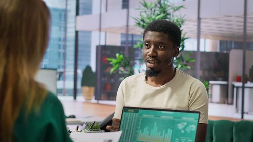 Young man using laptop at office