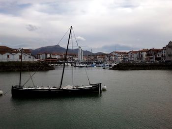Boats in river with buildings in background