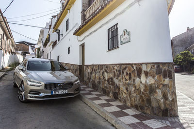 Cars on street by buildings in city