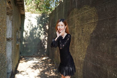 Portrait of smiling young woman standing outdoors