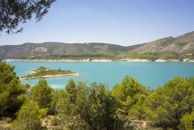 Scenic view of lake and trees against sky