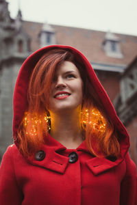 Close up attractive woman with red hood on street portrait picture