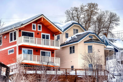 Houses and buildings against sky during winter