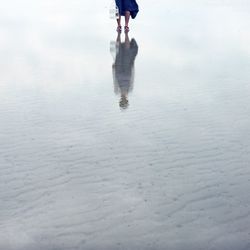 Low section of woman standing on tiled floor