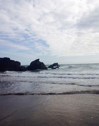 Scenic view of sea against cloudy sky