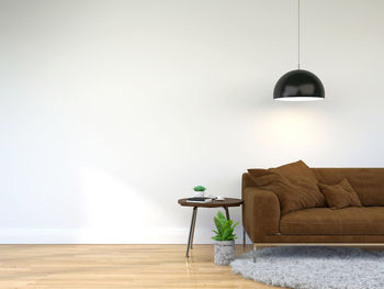Electric lamp on wooden floor against wall at home