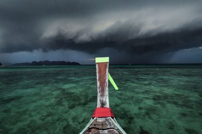 Scenic view of sea against storm clouds