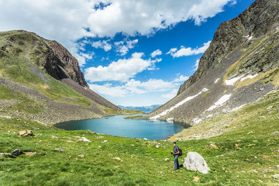 Photographer standing on field by lake