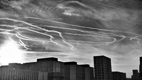 Low angle view of buildings against cloudy sky