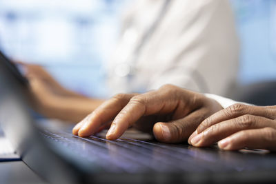 Midsection of woman using laptop
