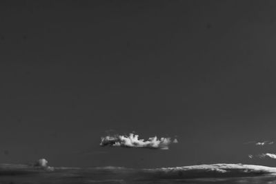 Low angle view of snow on sea against sky at night