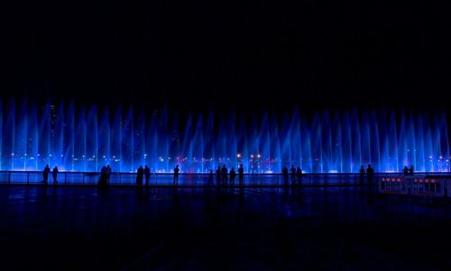 View of illuminated woman at night