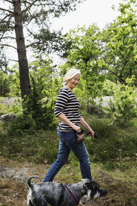 Rear view of woman with umbrella on land