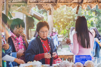 Group of people looking at market stall