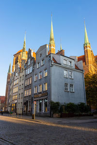 Buildings in city against blue sky
