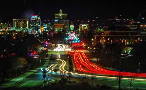 Illuminated light trails on road in city at night