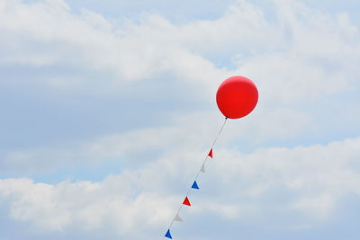 Low angle view of balloon flying against sky