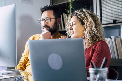 Business people looking at computer in office