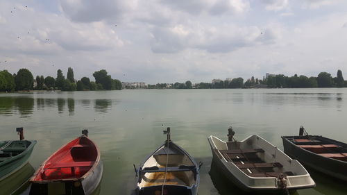 Panoramic view of boats moored in lake against sky