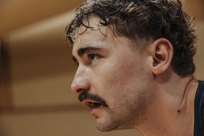 Focused male athlete with mustache at sports court