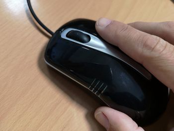 Close-up of person using mobile phone on table