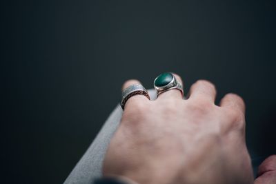 Close-up of man hand against black background