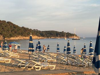 People at beach against sky