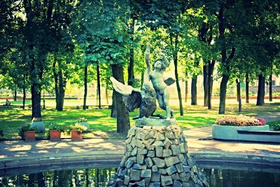 Statue against trees