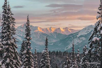 Scenic view of snowcapped mountains against sky during sunset