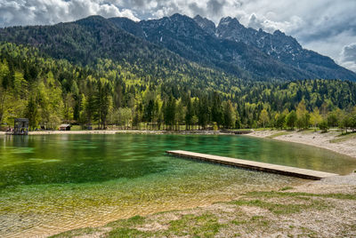 Scenic view of lake and mountains against sky