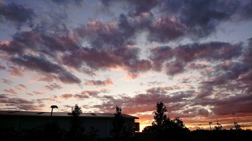 Silhouette of statue against sky at sunset