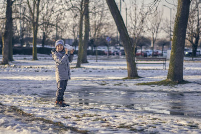 Full length of boy standing in snow