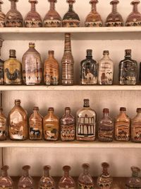Sand in bottles crafts on shelf in petra, jordan